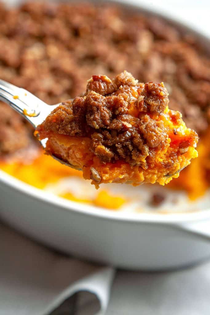 Sweet potato casserole - velvety smooth, sweet potatoes topped with the most amazing sweet, crunchy, pecan and brown sugar streusel. A must have on the Thanksgiving or holiday table. #sweet potatoes #casserole #dinner #Thanksgiving #holiday #from scratch #streusel #side dish #dessert