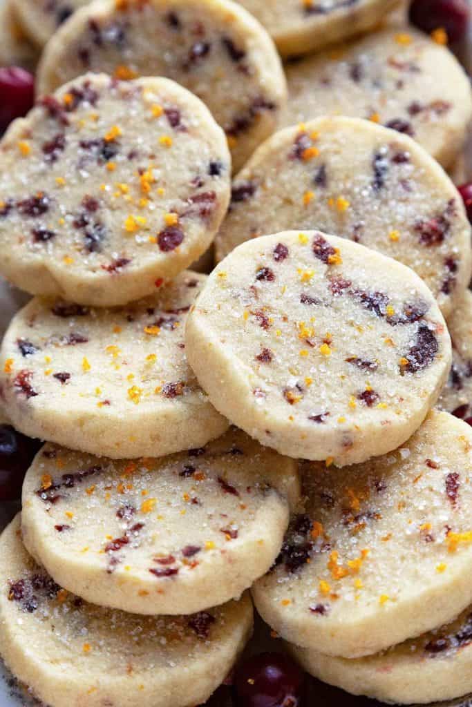 Cranberry Orange Cookies - a tender, buttery shortbread slice and bake cookie loaded with tangy cranberries and zingy orange. These easy-to-make cookies melt in your mouth! #cranberry #orange #cookies #holiday #shortbread #slice and bake #recipe #easy #melt in your mouth #best #buttery #traditional #cranberry orange #christmas