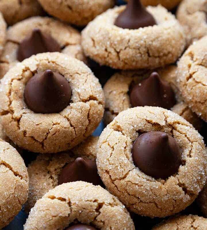 Peanut Butter Blossoms – soft and chewy peanut butter cookies topped with a chocolate kiss. Their sweet and salty combination is irresistible! #peanut butter blossoms #easy #from scratch #best #butter #peanut butter #cookies #holiday #christmas #without shortening #hersheys #soft #chewy #classic #original #perfect