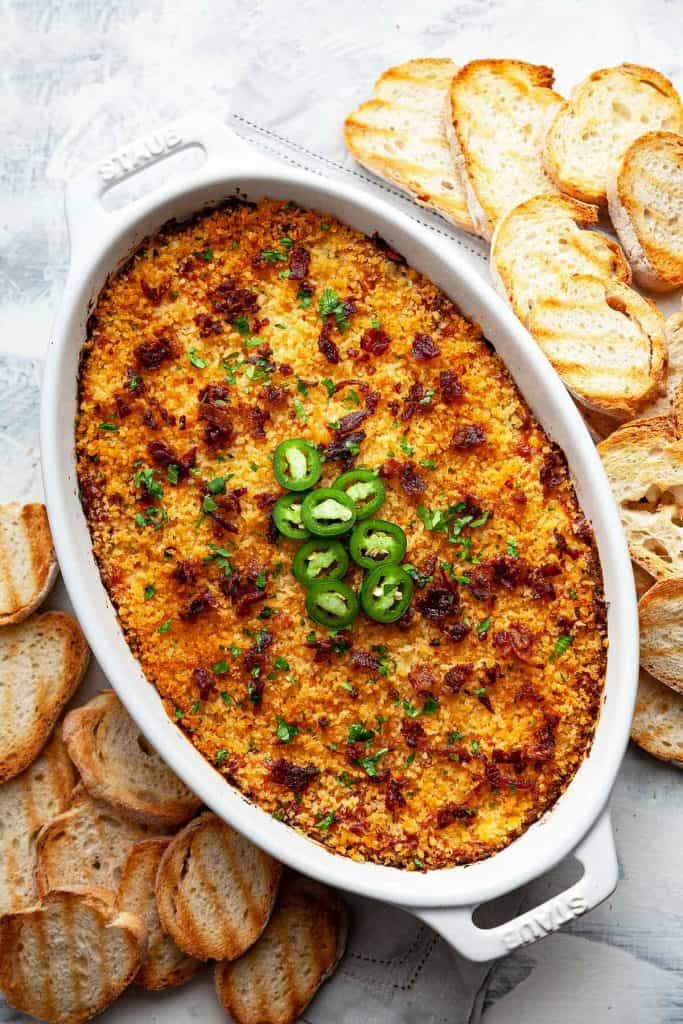This creamy, cheesy Jalapeno Popper Dip is quick, easy, and totally addictive. My favorite party appetizer! #jalapenopopperdip #bacon #best #easy #crockpot #recipe #baked #video #panko #nomayo #withsourcream #vegetarian #slowcooker #oven #party #gameday #appetizer