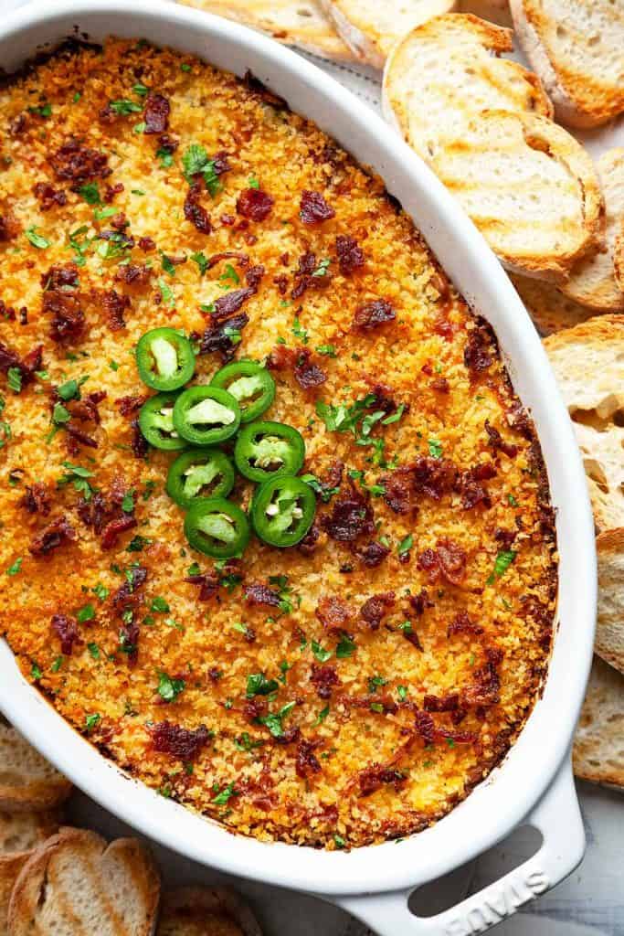This creamy, cheesy Jalapeno Popper Dip is quick, easy, and totally addictive. My favorite party appetizer! #jalapenopopperdip #bacon #best #easy #crockpot #recipe #baked #video #panko #nomayo #withsourcream #vegetarian #slowcooker #oven #party #gameday #appetizer