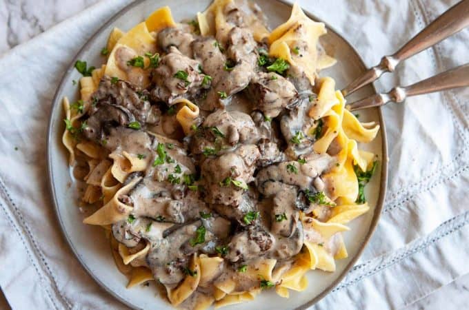 The most incredible Slow Cooker Beef Stroganoff you will ever have! Melt-in-your-mouth tender chunks of beef slowly simmered in a creamy mushroom sauce. As easy as it is delicious! A cozy, comforting meal the whole family will love. #beef #beefstroganoff #stroganoff #easy #crockpot #slowcooker #recipe #best #withstewmeat #traditional #creamy #videos #fromscratch #dinner #easydinner