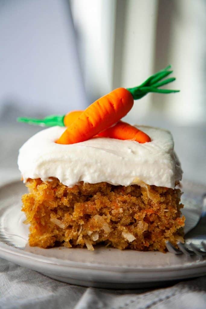 Incredibly moist and so delicious! This is my favorite Carrot Cake recipe – a super moist and tender Carrot Cake bursting with flavor from pineapple and coconut, topped with the most heavenly cream cheese frosting. #easy #best #recipe #healthy #homemade #cupcakes #decoration #pineapple #creamcheesefrosting #dessert #spring #easter 