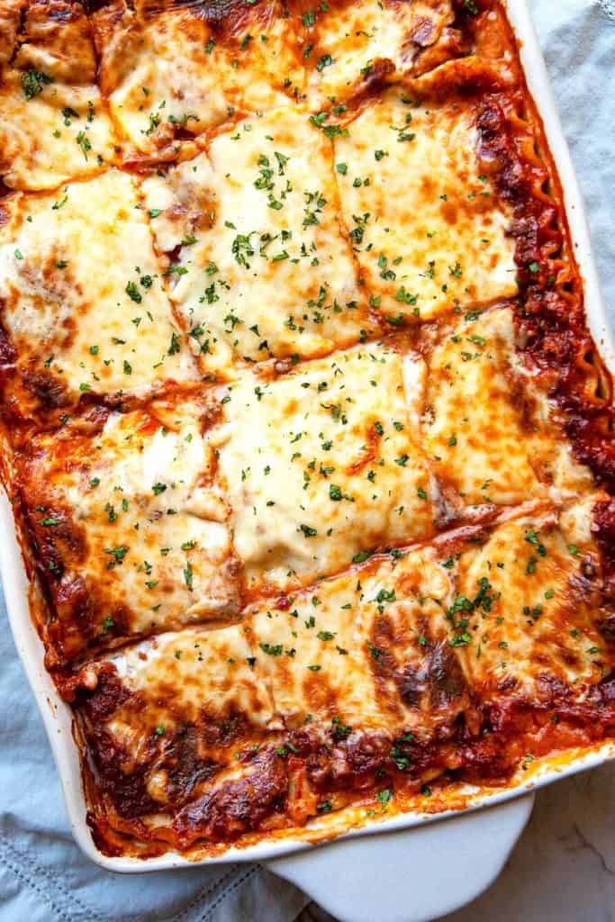 Classic Lasagna - layers of silky smooth, creamy parmesan béchamel sauce, a slow simmered Bolognese meat sauce, sheets of pasta, and lots of mozzarella cheese make this the World’s Best Lasagna recipe.