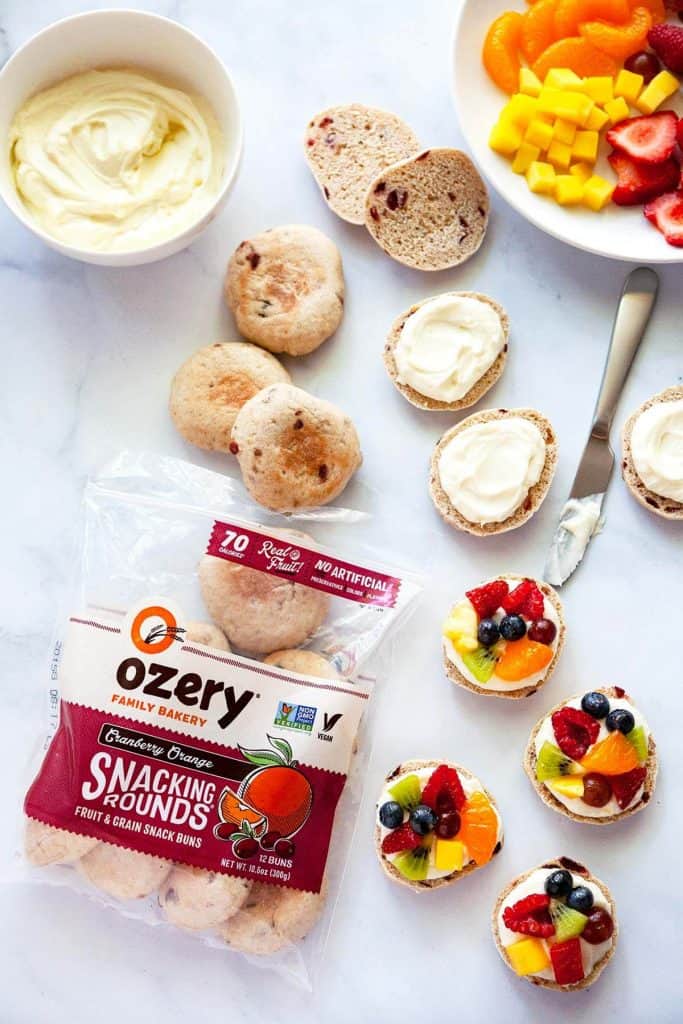 Mini Fruit Pizzas with fresh juicy fruit, velvety smooth cream cheese, and a soft, chewy crust. A delicious and healthy snack your whole family will love! Quick and easy to make with wholesome ingredients you can feel good about serving.