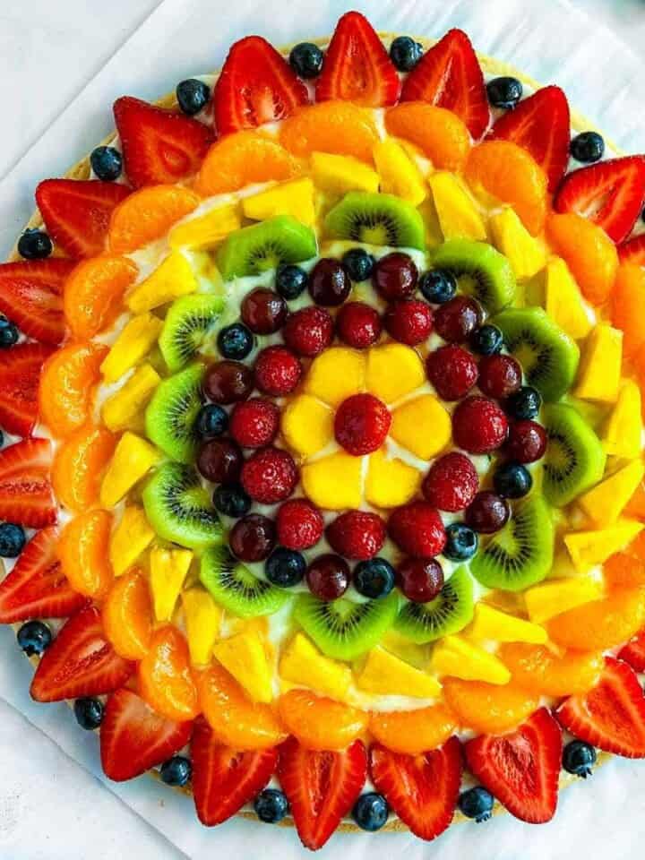 Fruit Pizza - The BEST summer dessert! With a soft sugar cookie crust, dreamy cream cheese frosting, and topped with fresh fruit. Super simple to make and always a hit!