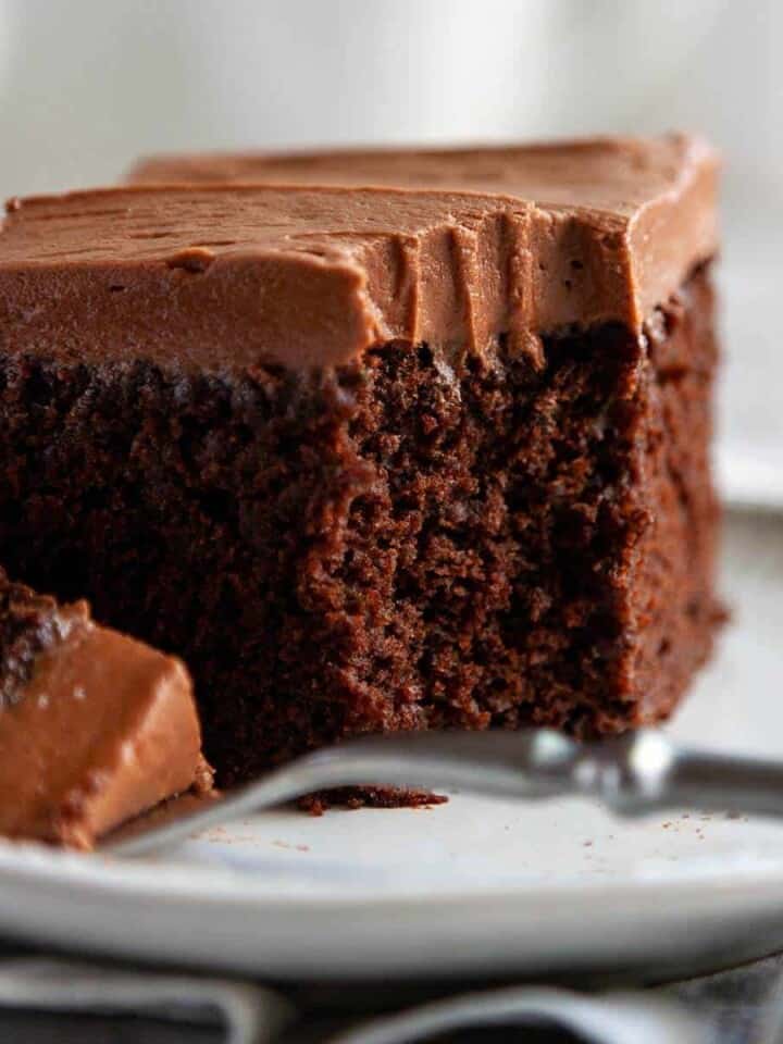 Chocolate Zucchini Cake - an incredibly moist chocolate cake topped with a cloud of chocolate cream cheese frosting. #dessert