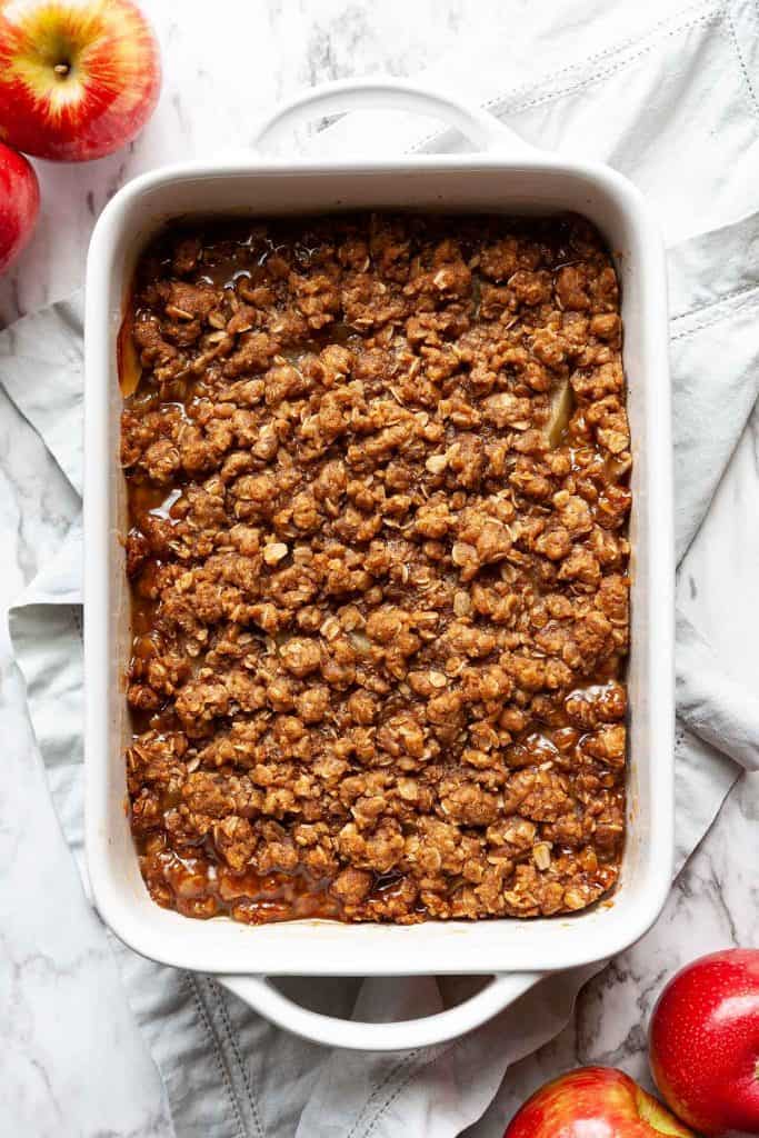 Quick and Easy Apple Crisp is bursting with sweet, juicy apples and a crunchy oat topping. This easy fruit crisp recipe is perfect served warm from the oven topped with a scoop of vanilla ice cream. The quintessential fall dessert recipe!