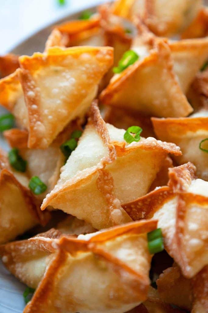The BEST Crab Rangoon - A lush and creamy crab and cream cheese filling in a crispy wonton – the perfect party appetizer or game day snack recipe! With instructions for frying, baking, or air frying, they’re easy to make and always a hit!