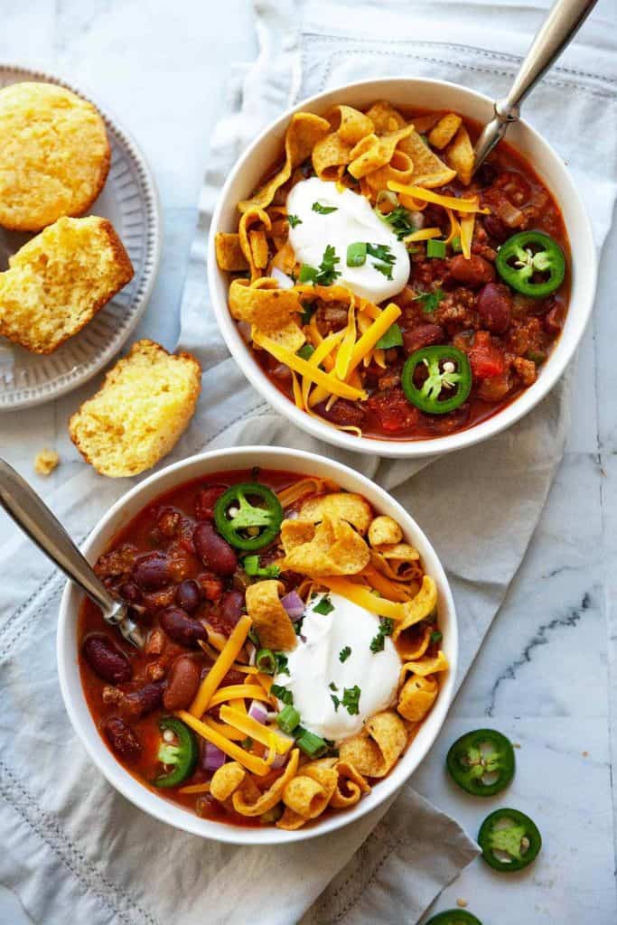 The best classic Chili recipe, ready in 30 minutes! Loaded with ground beef, tender beans, tomatoes, and a simple homemade blend of chili seasoning, piled high with all of your favorite toppings. So much flavor! 