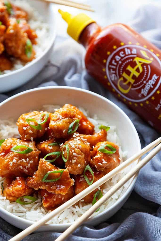 Honey Sriracha Chicken – little flavor bombs of light, crispy chunks of chicken in the most amazing tangy, sweet, and spicy Honey Sriracha Sauce. Quick and easy, you’ll love this sweet and spicy chicken recipe that’s big on flavor and ready in under 30 minutes!
