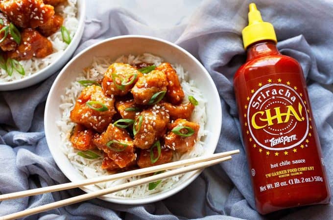 Honey Sriracha Chicken – little flavor bombs of light, crispy chunks of chicken in the most amazing tangy, sweet, and spicy Honey Sriracha Sauce. Quick and easy, you’ll love this sweet and spicy chicken recipe that’s big on flavor and ready in under 30 minutes!