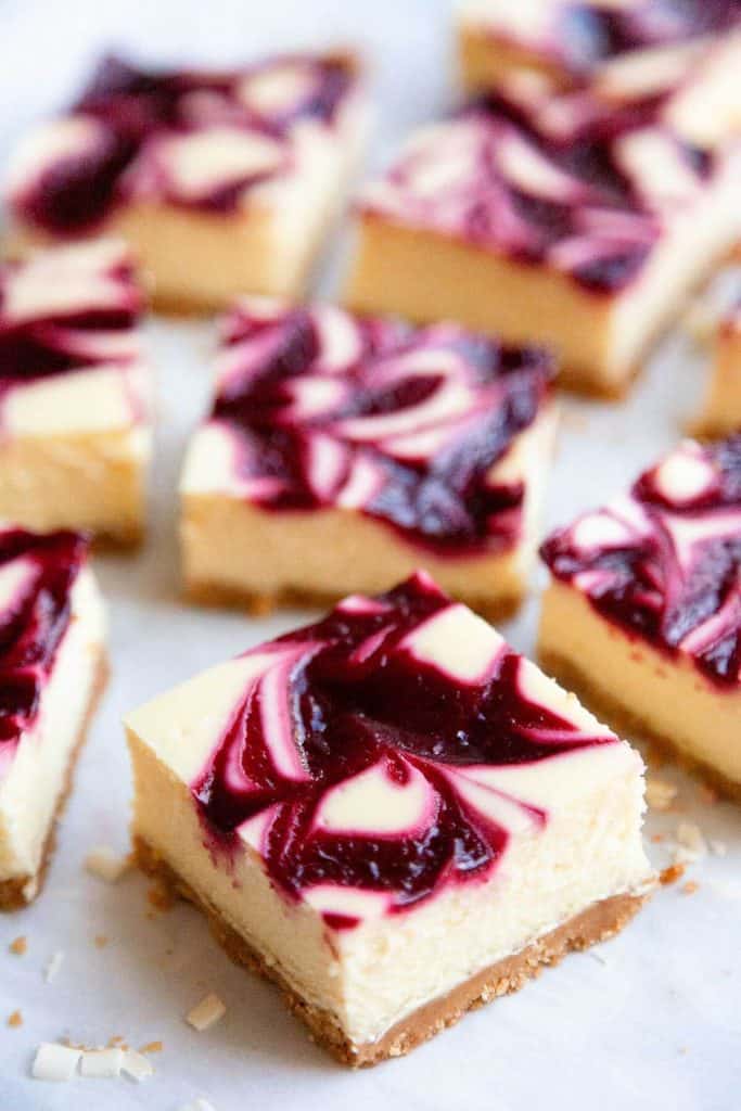 White Chocolate Raspberry Cheesecake Bars are lush and decadent with a rich and creamy, white chocolate cheesecake filling and a raspberry swirl. Super easy to make recipe and perfect for any occasion!