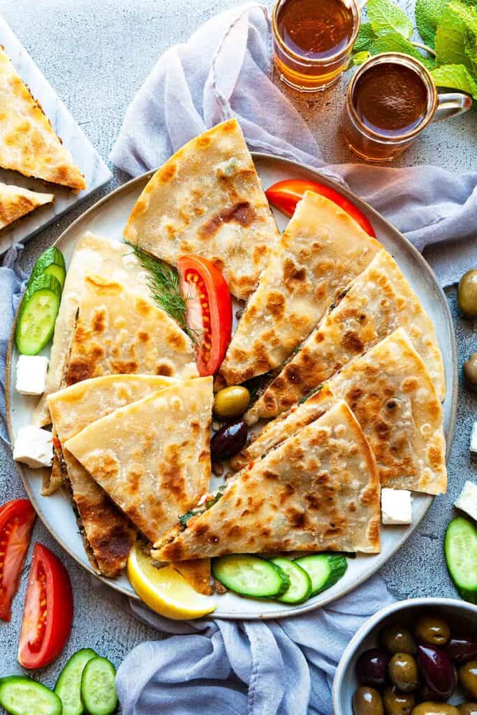 Turkish Gozleme Recipe– easy, homemade, Turkish flatbread stuffed with your choice of four fillings: spicy lamb or beef, spinach and feta, cheese and herb, and potato and cheese. An easy to make recipe without yeast!