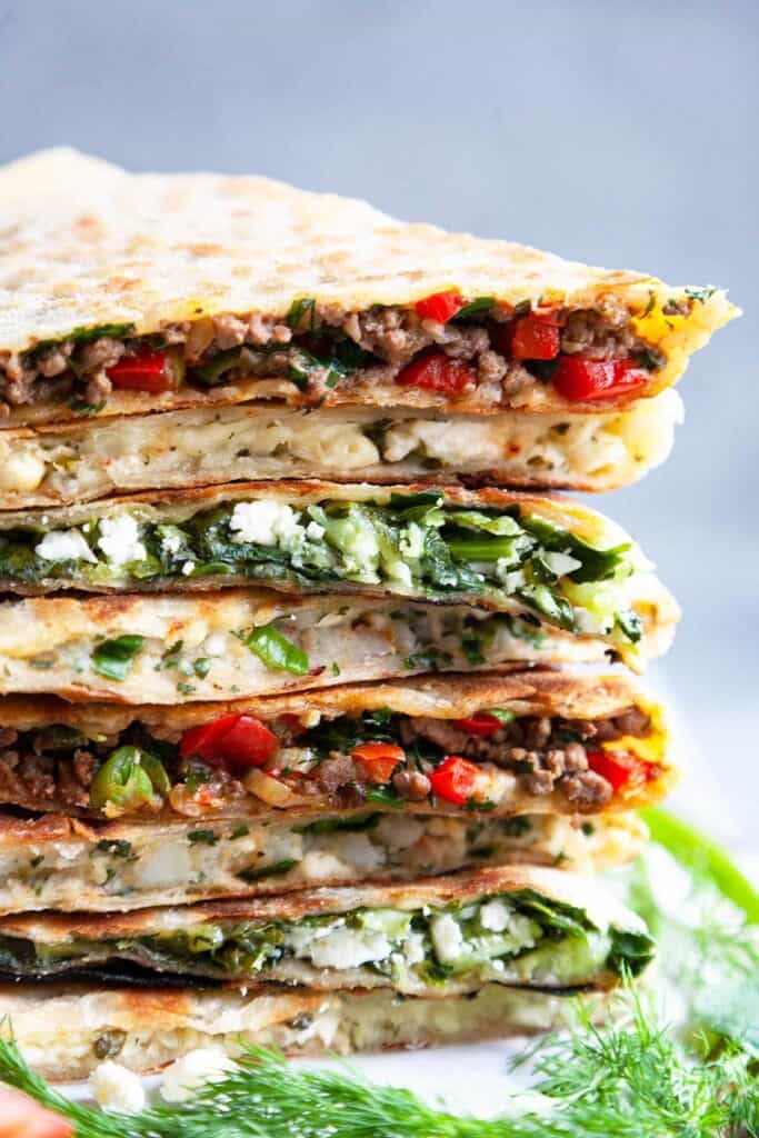 Turkish Gozleme Recipe– easy, homemade, Turkish flatbread stuffed with your choice of four fillings: spicy lamb or beef, spinach and feta, cheese and herb, and potato and cheese. An easy to make recipe without yeast!