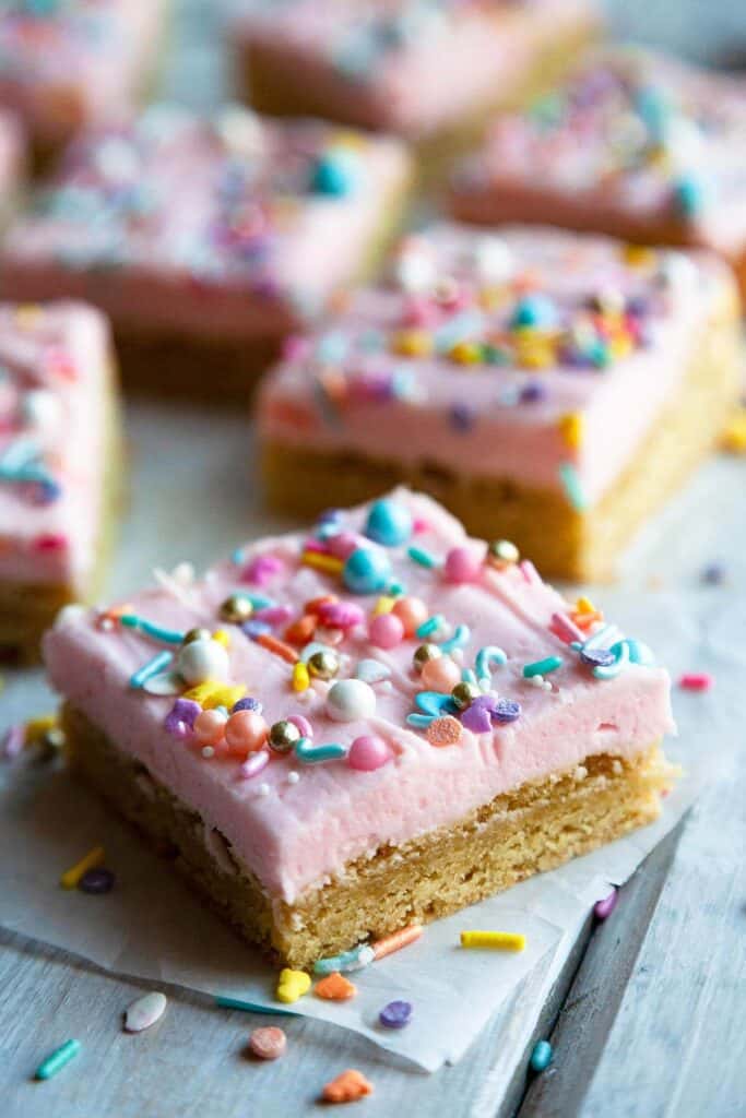 The BEST thick and chewy Sugar Cookie Bars with vanilla buttercream frosting. Quick and easy to make bar cookies recipe! #dessert #homemade #fromscratch
