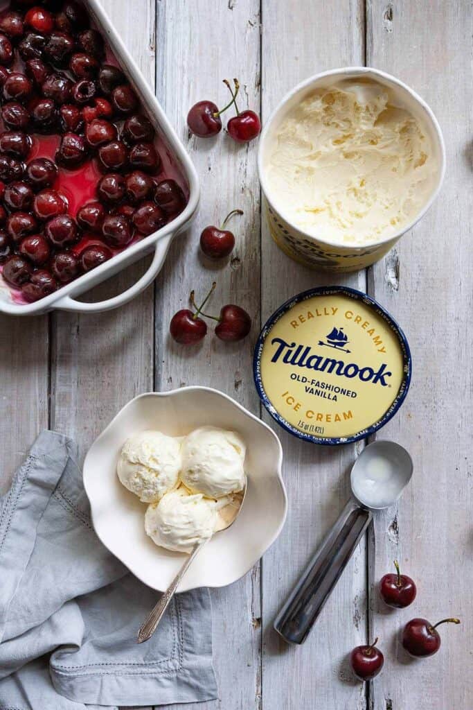 Tillamook ice cream in container, a dish of roasted cherry sauce, and a bowl of ice cream