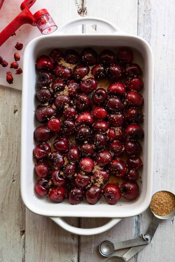 baking dish containing cherries sprinkled with sugar