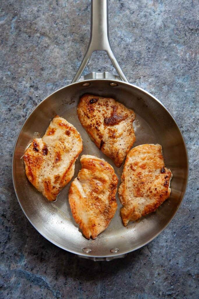 pan with sautéed chicken breasts