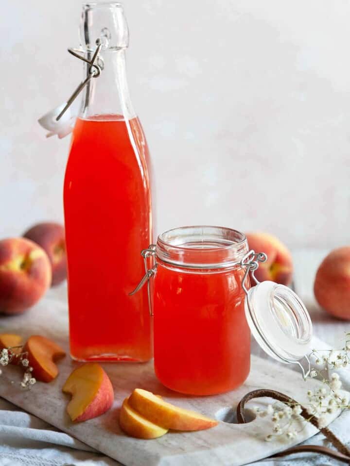 a bottle and a jar of peach syrup