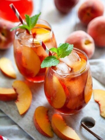 glasses of peach iced tea and peaches