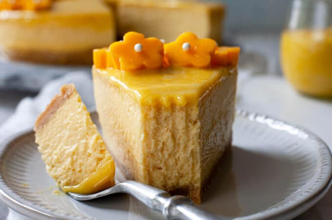 a slice of mango cheesecake with a bite taken out