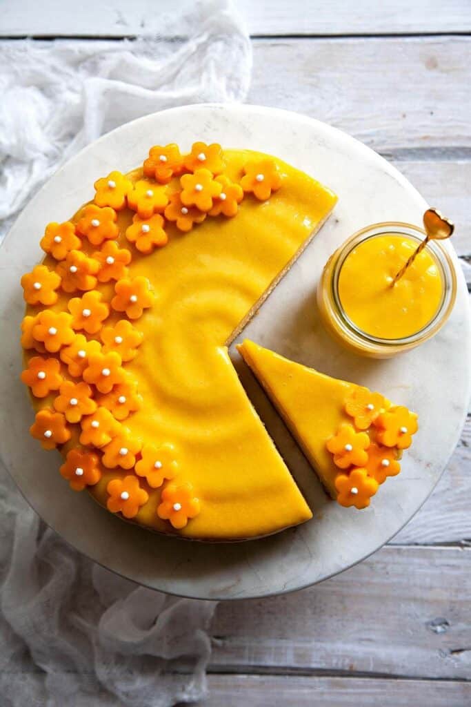 mango cheesecake on a serving plate with mango curd