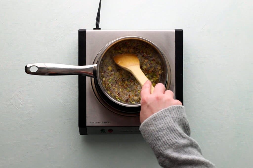 stirring pistachio syrup in pan
