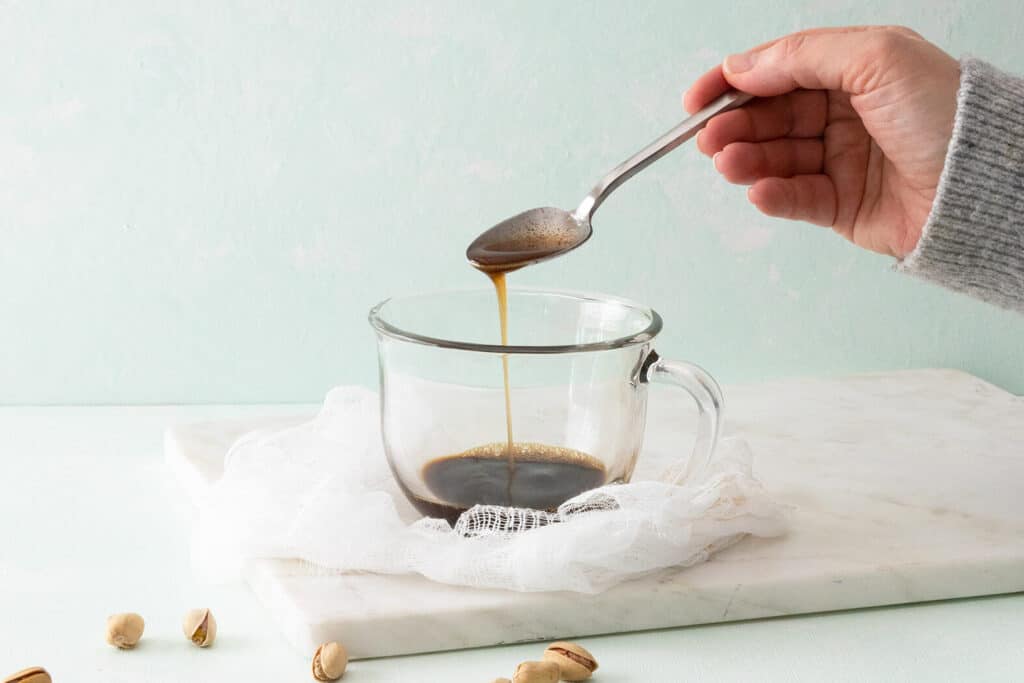 pouring browned butter into espresso