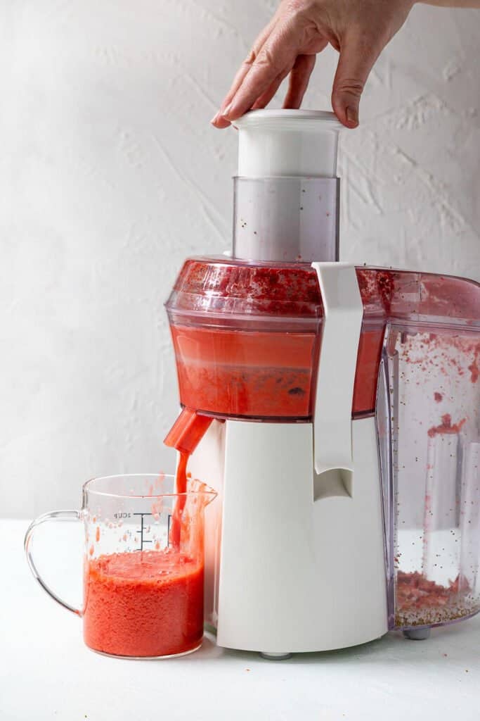 making strawberry juice in juicer machine
