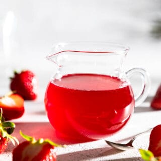 small pitcher of strawberry syrup