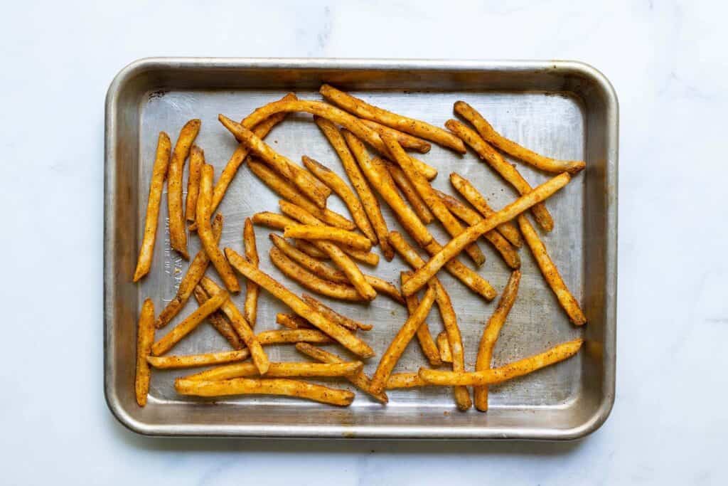 french fries baked on a baking sheet