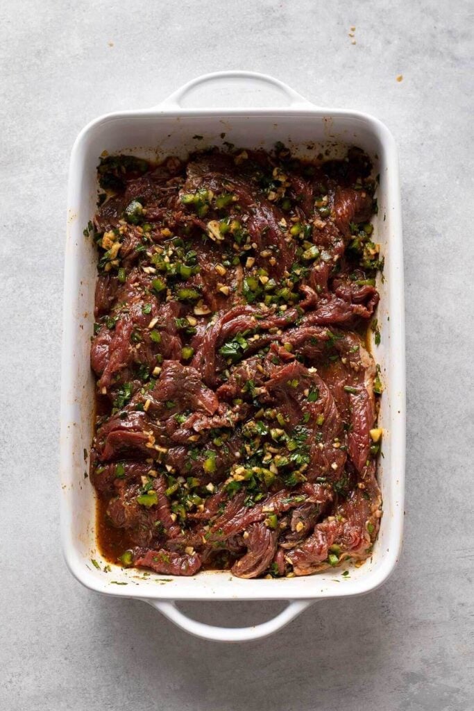 dish with raw steak and marinade