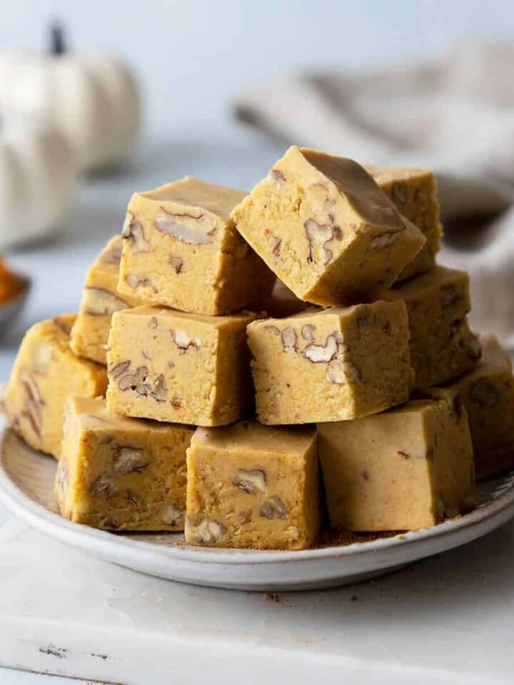 pumpkin fudge squares stacked on a plate