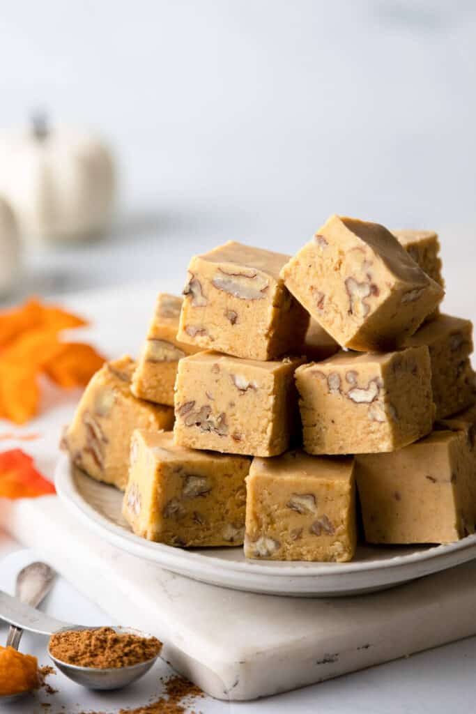 pumpkin fudge squares stacked on a plate