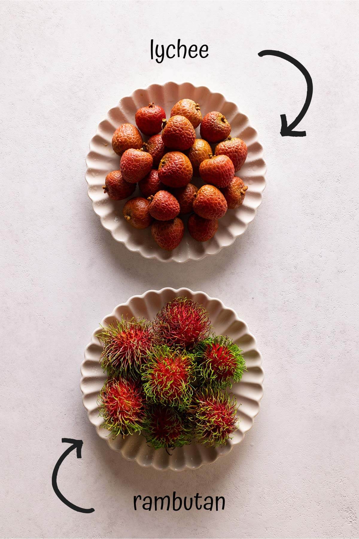a dish of lychee and a dish of rambutan