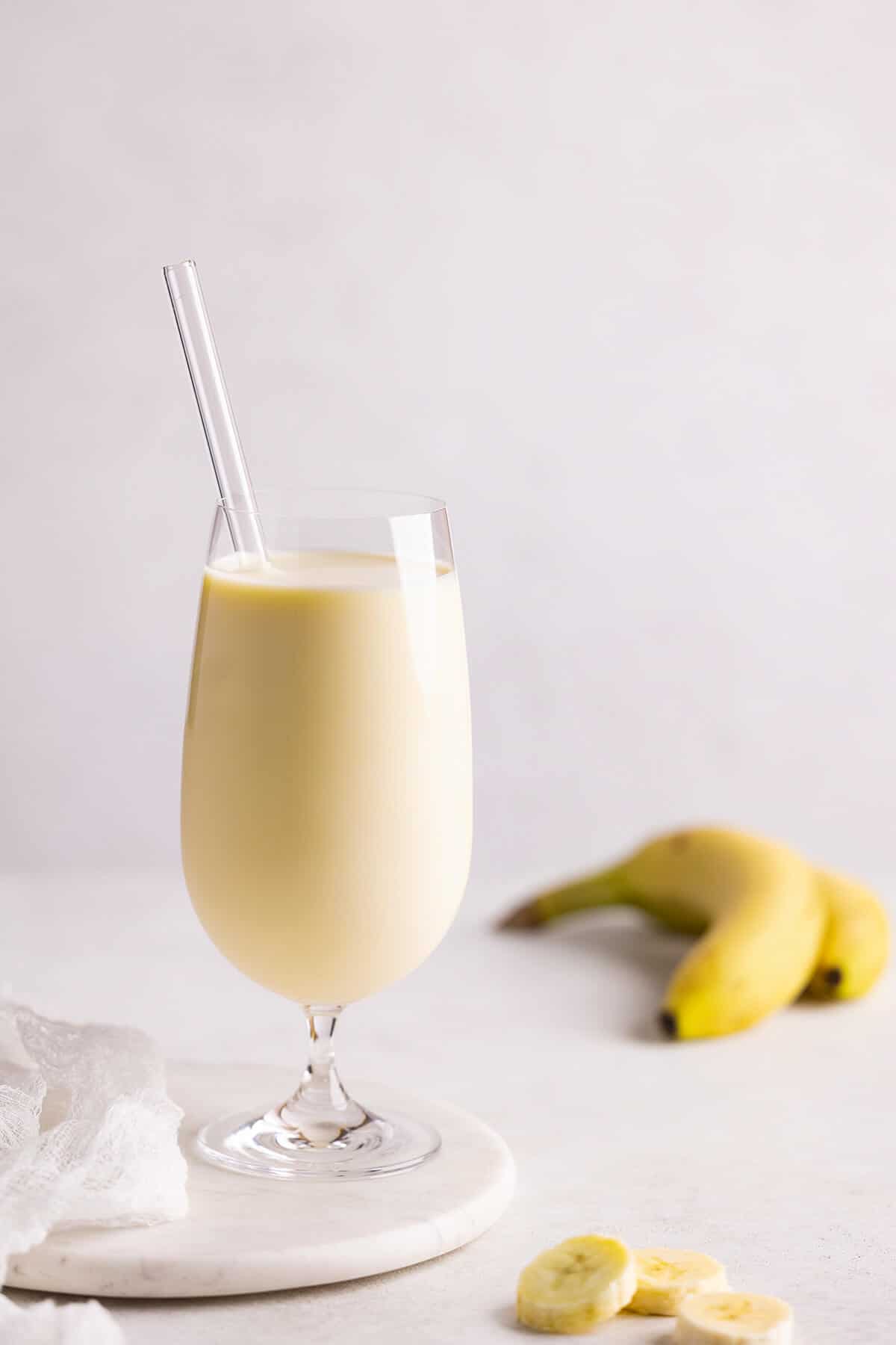 glass of banana milk with straw