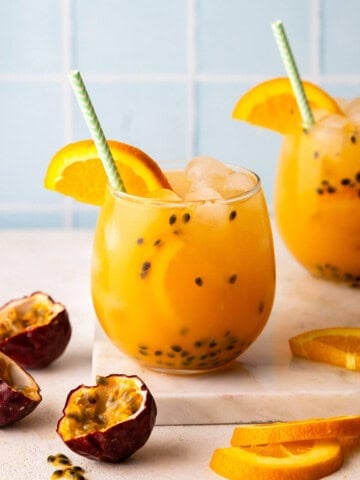 two glasses of passion fruit, orange, guava juice